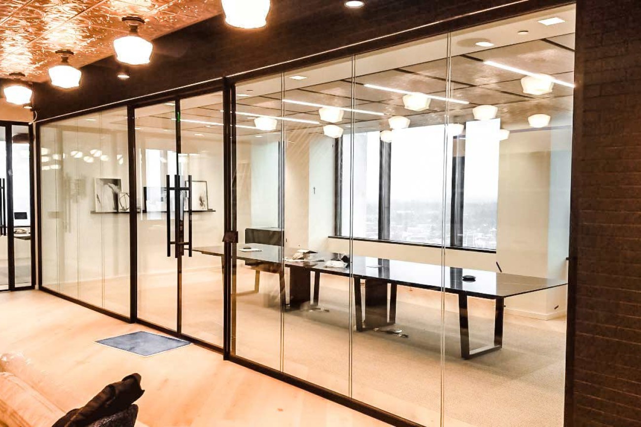 Architectural glass wall installation for a commercial conference room and meeting space.