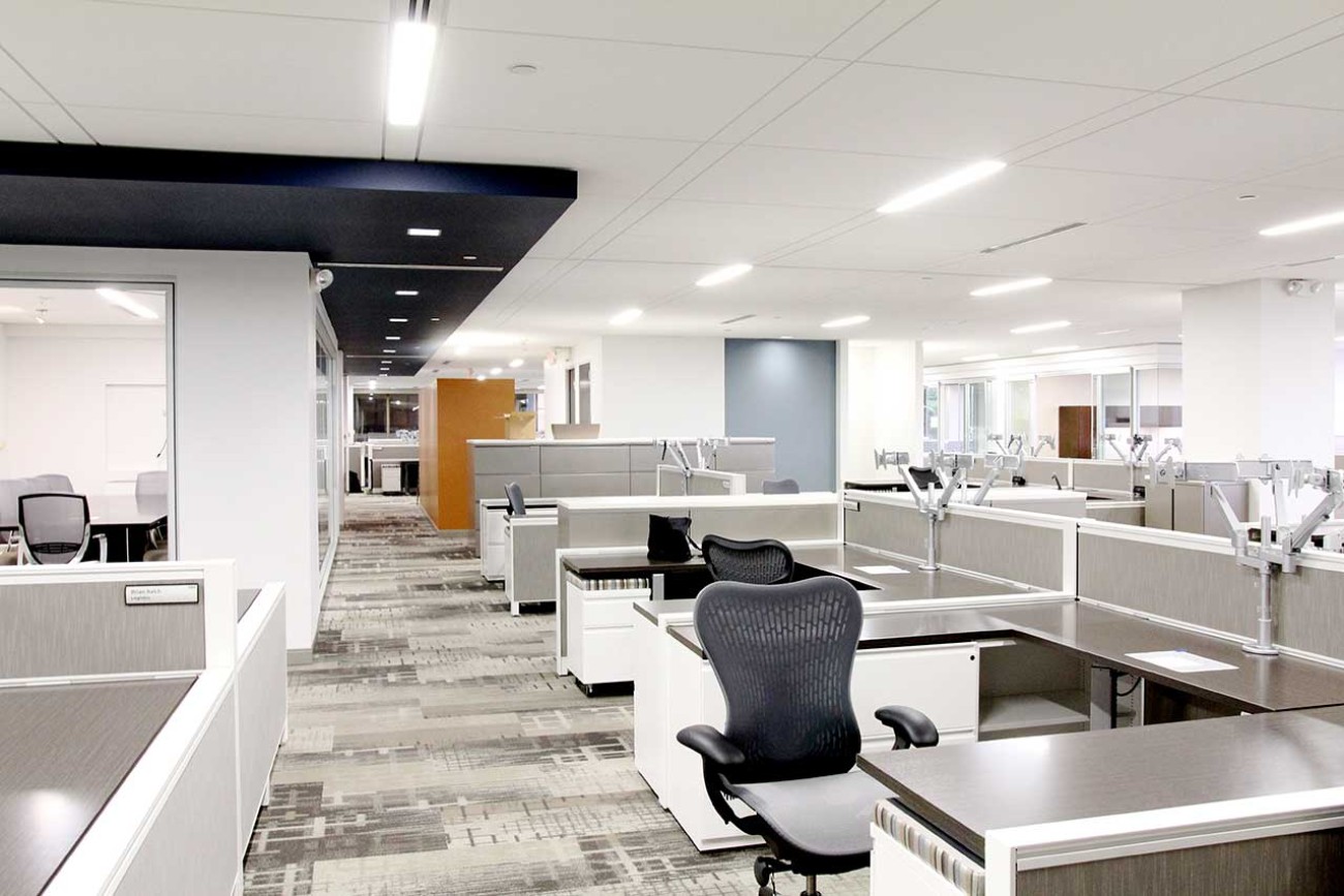 Commercial office workstations and furniture systems installed in a modern open office.